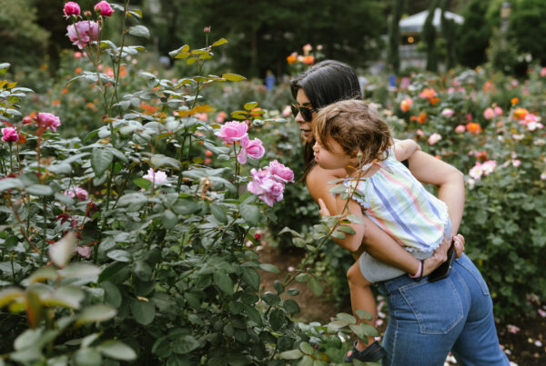 A Mother and Child smelling the roses on Mother's Day